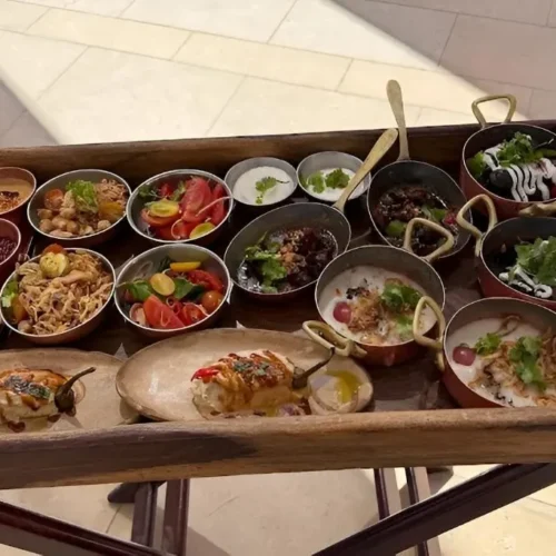 Wooden tray of Egyptian mezze in copper pots and ceramic bowls at Khufu Restaurant